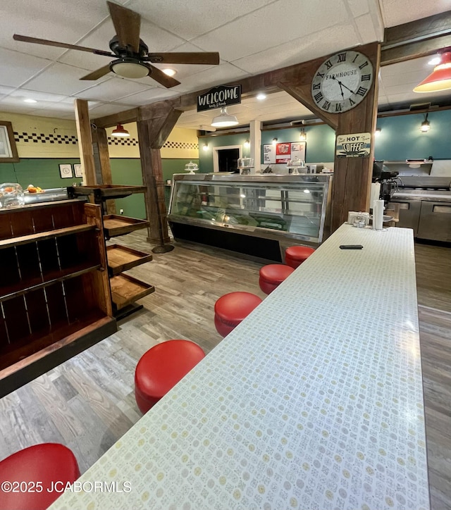 106 S Main St, Chamois, MO 65024 - bar area featuring a paneled ceiling, wood finished floors, and ceiling fan