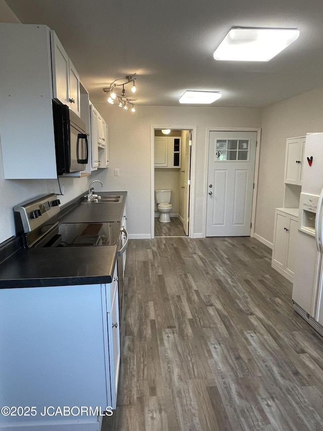 106 S Main St, Chamois, MO 65024 - kitchen featuring black microwave, dark countertops, a sink, electric stove, and dark wood-style flooring