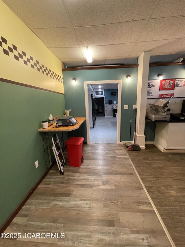106 S Main St, Chamois, MO 65024 - corridor featuring wood finished floors, baseboards, and a drop ceiling
