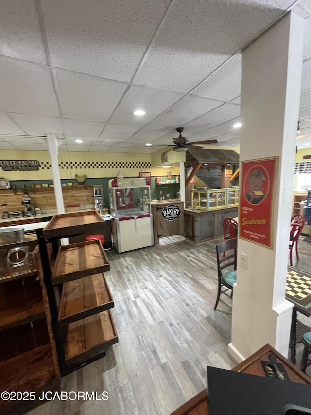 106 S Main St, Chamois, MO 65024 - dining area with a ceiling fan, light wood-style flooring, and a drop ceiling