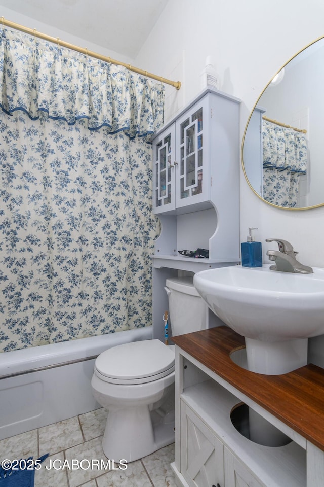 bathroom featuring tile patterned flooring and toilet