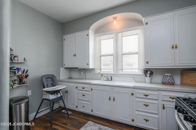 kitchen featuring white cabinetry, sink, and stainless steel range oven