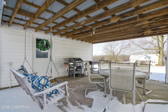 snow covered patio featuring a grill