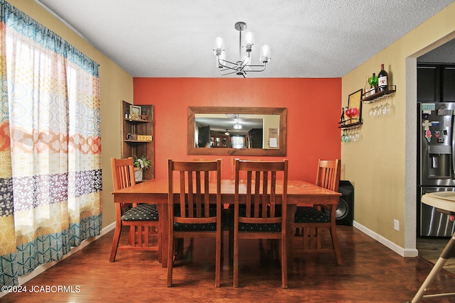 dining room featuring hardwood / wood-style floors, a chandelier, and a textured ceiling