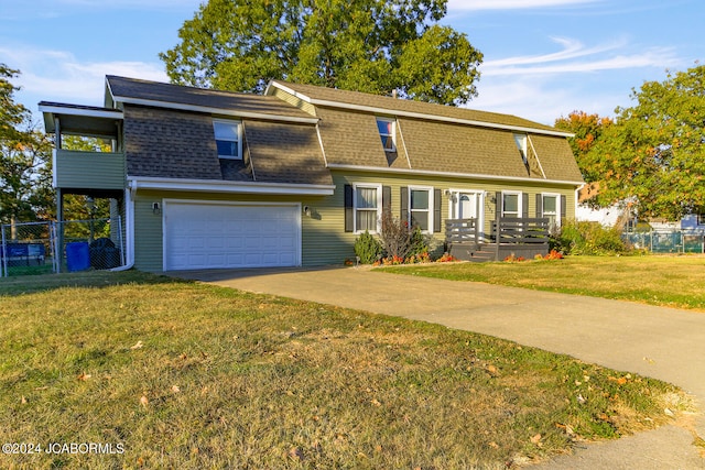 view of front of home featuring a garage and a front yard