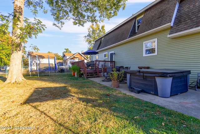 view of yard with a wooden deck and a patio