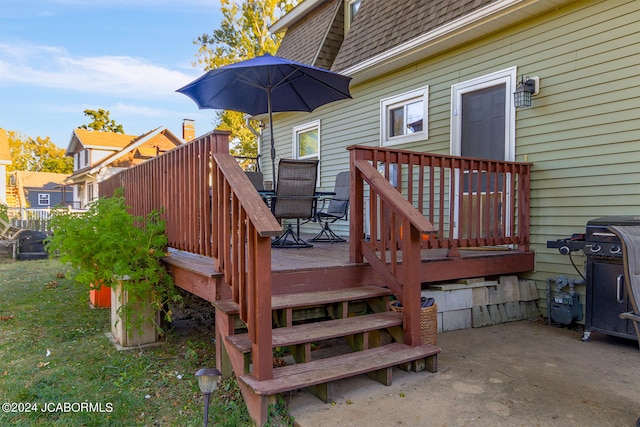 wooden deck with a patio and grilling area