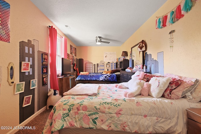 carpeted bedroom with ceiling fan and a textured ceiling