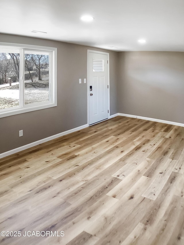 foyer with recessed lighting, baseboards, and wood finished floors