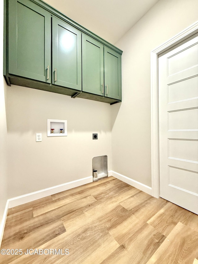5519 Kenview Dr, Jefferson City, MO 65109 - washroom with baseboards, hookup for a washing machine, cabinet space, and light wood-style floors
