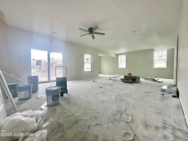 unfurnished living room with ceiling fan and visible vents