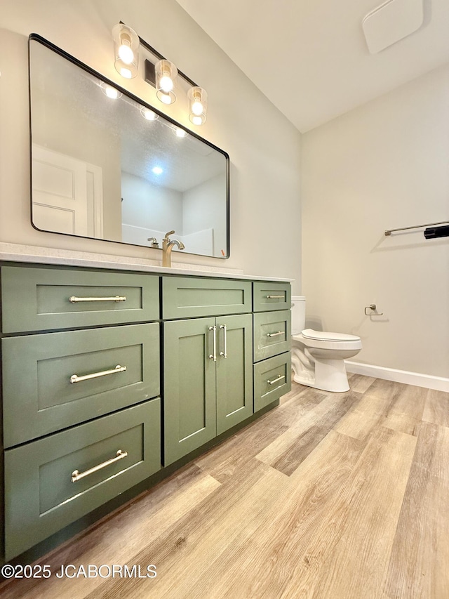 5519 Kenview Dr, Jefferson City, MO 65109 - bathroom featuring toilet, baseboards, vanity, and wood finished floors