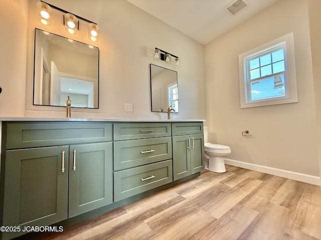 5519 Kenview Dr, Jefferson City, MO 65109 - full bathroom with toilet, baseboards, double vanity, and wood finished floors
