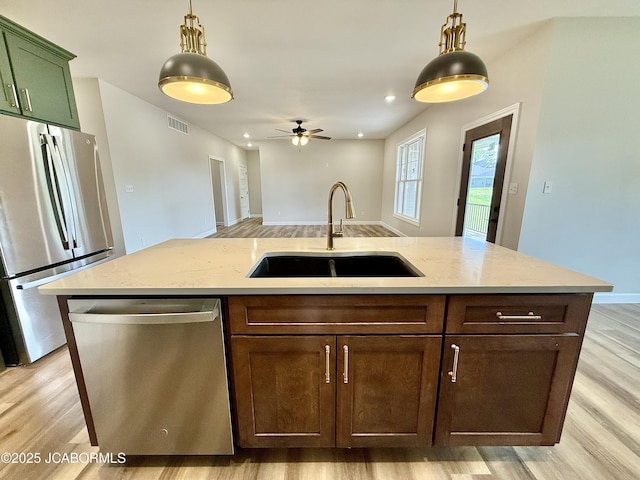 5519 Kenview Dr, Jefferson City, MO 65109 - kitchen with light wood-style flooring, decorative light fixtures, visible vents, a sink, and appliances with stainless steel finishes