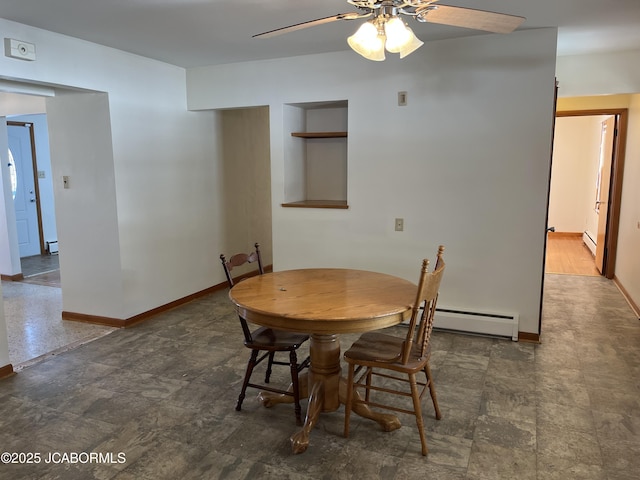 dining room with baseboard heating and ceiling fan