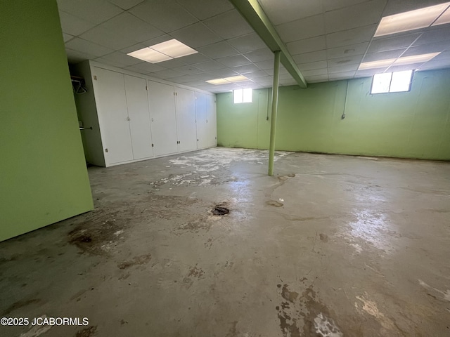 basement with a paneled ceiling