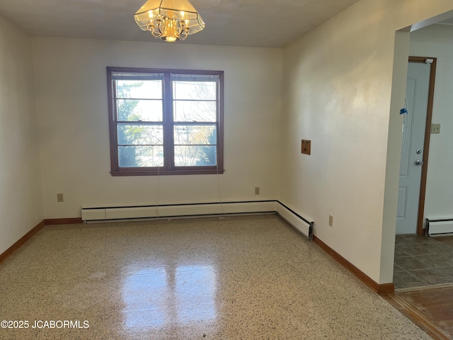 spare room featuring a baseboard radiator and a notable chandelier