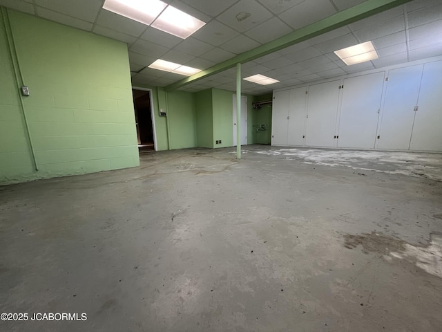 basement featuring a paneled ceiling