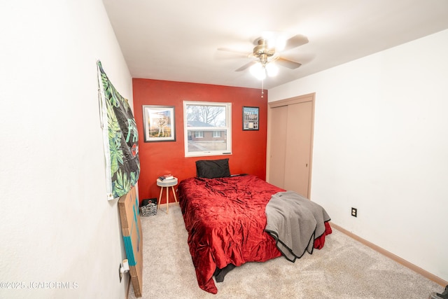 bedroom with carpet flooring, ceiling fan, and a closet