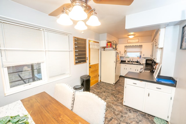 kitchen with sink, white fridge, and white cabinets