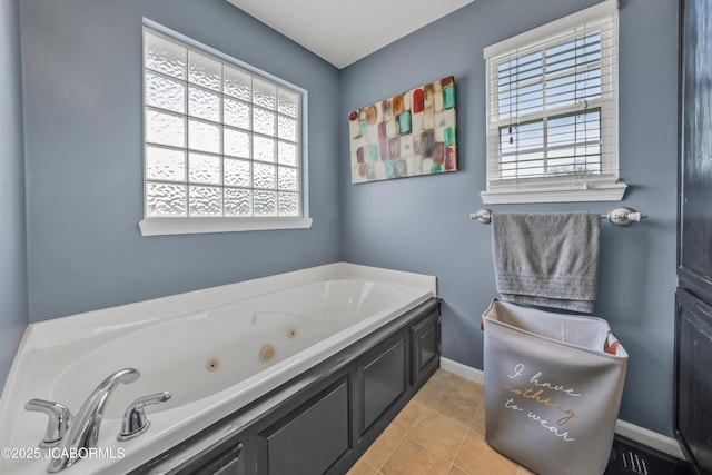full bathroom featuring tile patterned floors, a tub with jets, and baseboards