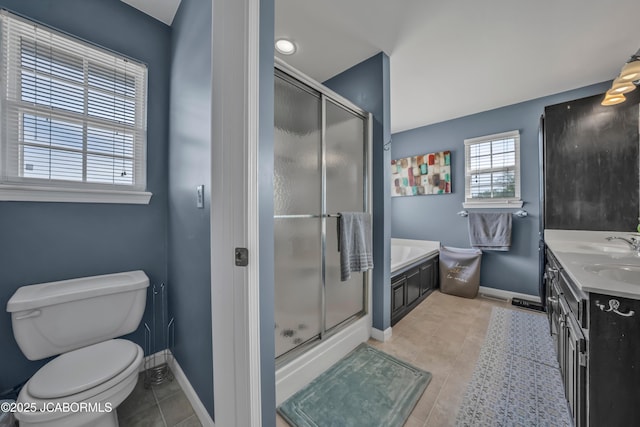 bathroom with baseboards, tile patterned flooring, a stall shower, and toilet