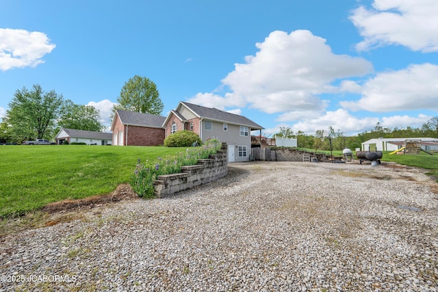 exterior space featuring a yard and gravel driveway