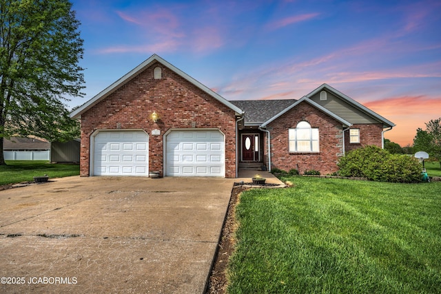 ranch-style home featuring an attached garage, brick siding, a front yard, and concrete driveway