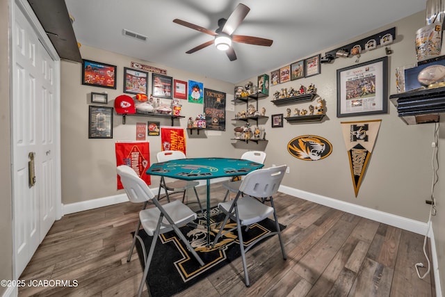 recreation room with visible vents, baseboards, ceiling fan, and wood finished floors