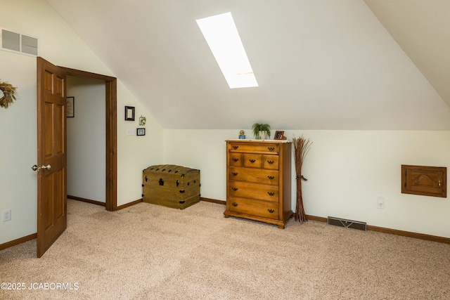 bonus room with lofted ceiling with skylight and light carpet