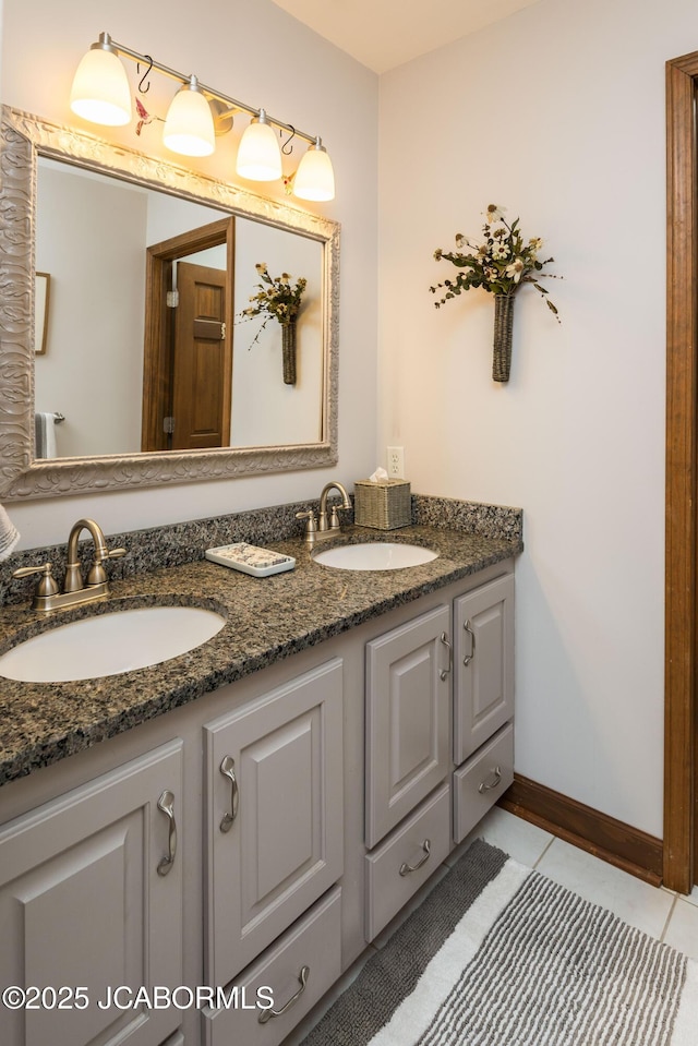 bathroom featuring tile patterned flooring, double vanity, and a sink