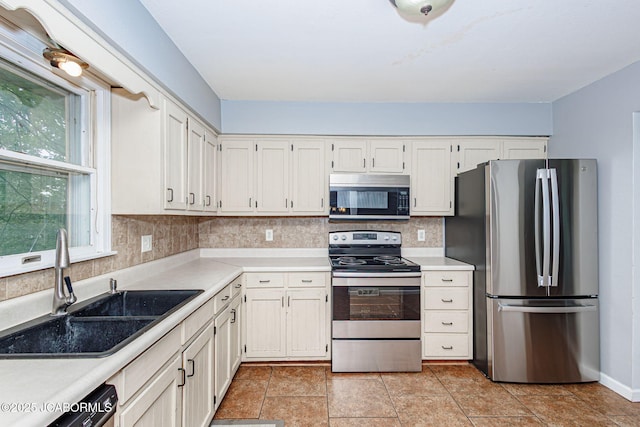 362 Vanhorn Rd, Holts Summit, MO 65043 - kitchen featuring appliances with stainless steel finishes, decorative backsplash, light countertops, and white cabinetry