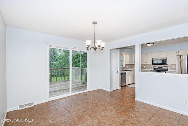 362 Vanhorn Rd, Holts Summit, MO 65043 - kitchen with stainless steel appliances, a chandelier, tasteful backsplash, hanging light fixtures, and white cabinets