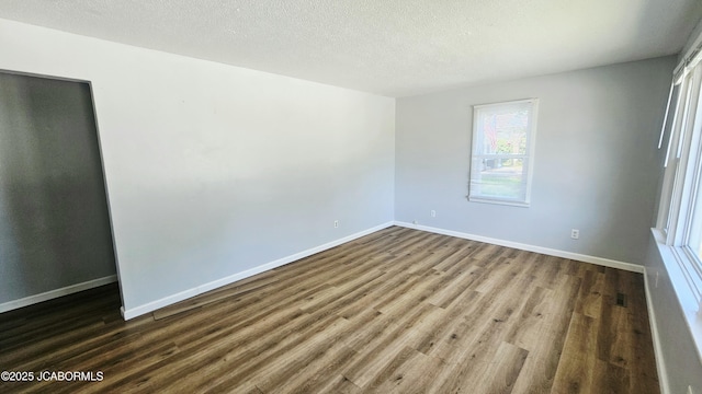 402 W 9th St, Fulton, MO 65251 - unfurnished room with dark wood-style flooring and a textured ceiling