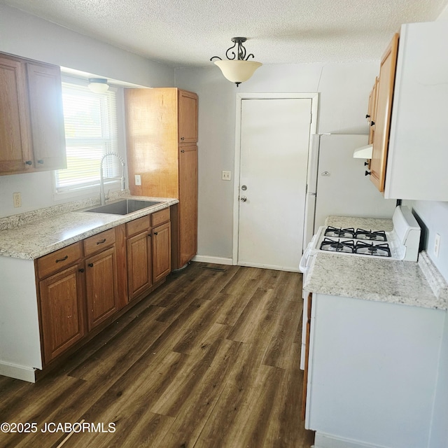 402 W 9th St, Fulton, MO 65251 - kitchen with dark wood-style floors, a textured ceiling, exhaust hood, brown cabinetry, and white appliances