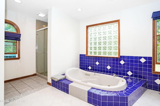 bathroom featuring tile patterned floors and shower with separate bathtub