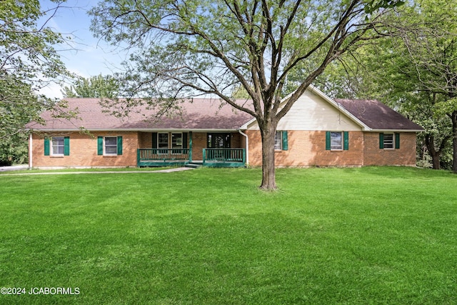 single story home with covered porch and a front lawn