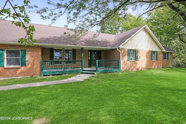 ranch-style house with a front yard and a porch