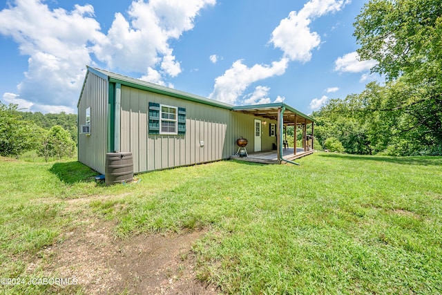 back of property featuring a lawn and a wooden deck