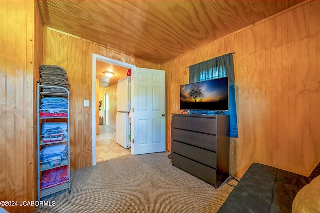 carpeted bedroom with wooden walls and wood ceiling