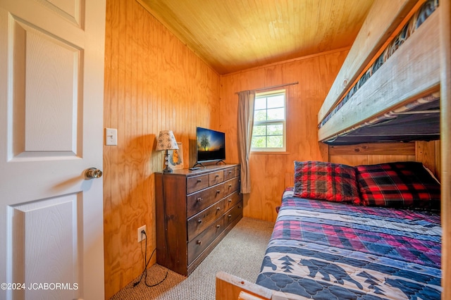 bedroom featuring wooden ceiling and wood walls