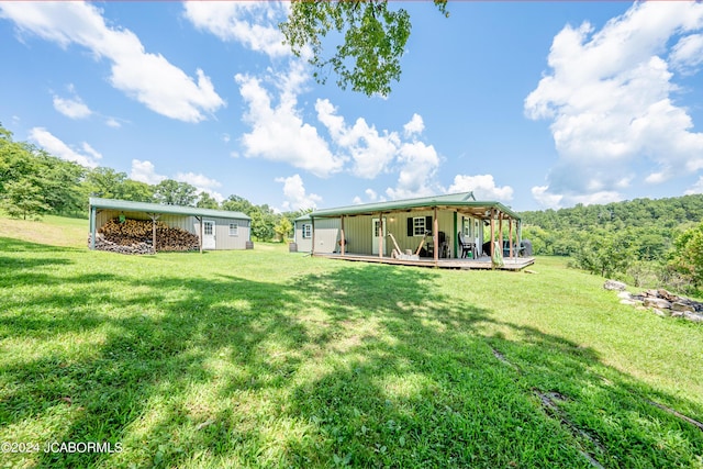 rear view of property with a yard