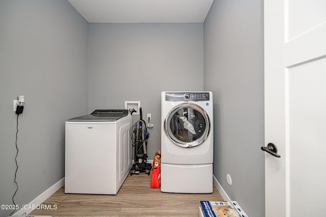 washroom featuring washer and clothes dryer and light wood-type flooring