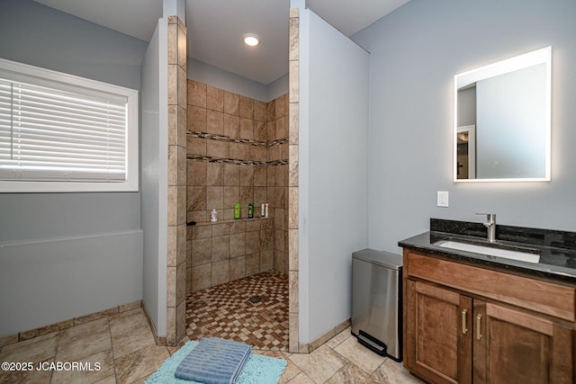 bathroom featuring vanity and tiled shower