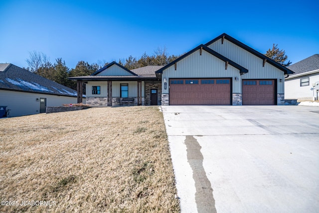 view of front of home featuring a garage, covered porch, and a front lawn