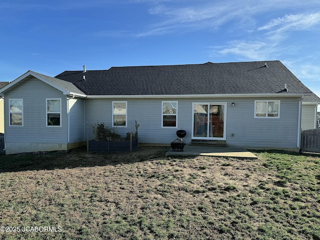 rear view of house featuring roof with shingles, fence, cooling unit, a yard, and a patio area