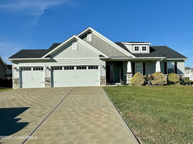 craftsman house featuring a garage, stone siding, a front lawn, and concrete driveway