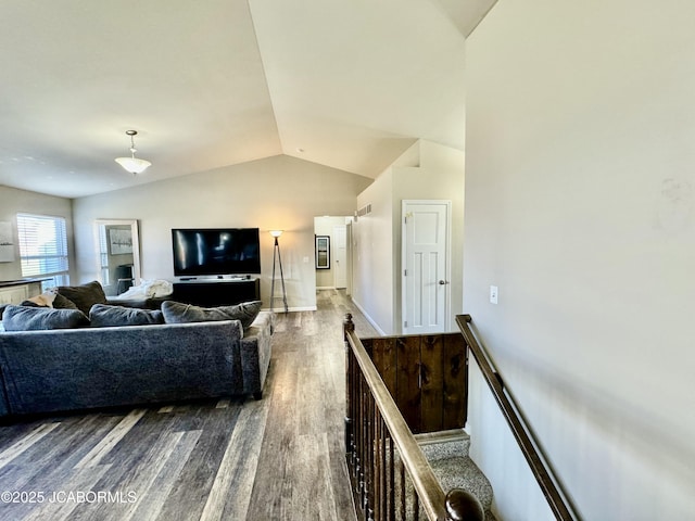 living room featuring vaulted ceiling and wood finished floors