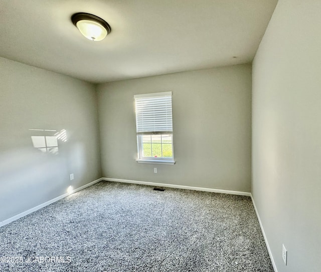 empty room with carpet and baseboards