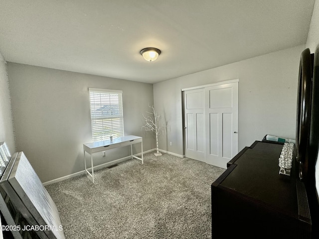 bedroom featuring carpet, a closet, and baseboards